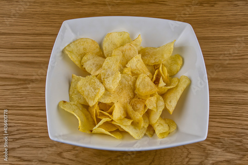 Potato chip crisps in a white bowl