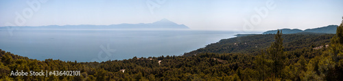 Panoramic View of Singitic Gulf in Aegean Sea with Mount Athos Peninsula Pine and Fir Tree Forest Under Blue Sky - Sea Landscape Sight from Mountain Road on Sithonia Chalkidiki Greece