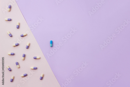 Medications versus one pill on multicolored pastel background. Placebo effect concept. Copy space. photo