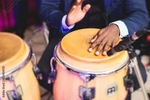 Fotografia, Obraz Bongo drummer percussionist performing on a stage with conga drums set kit durin