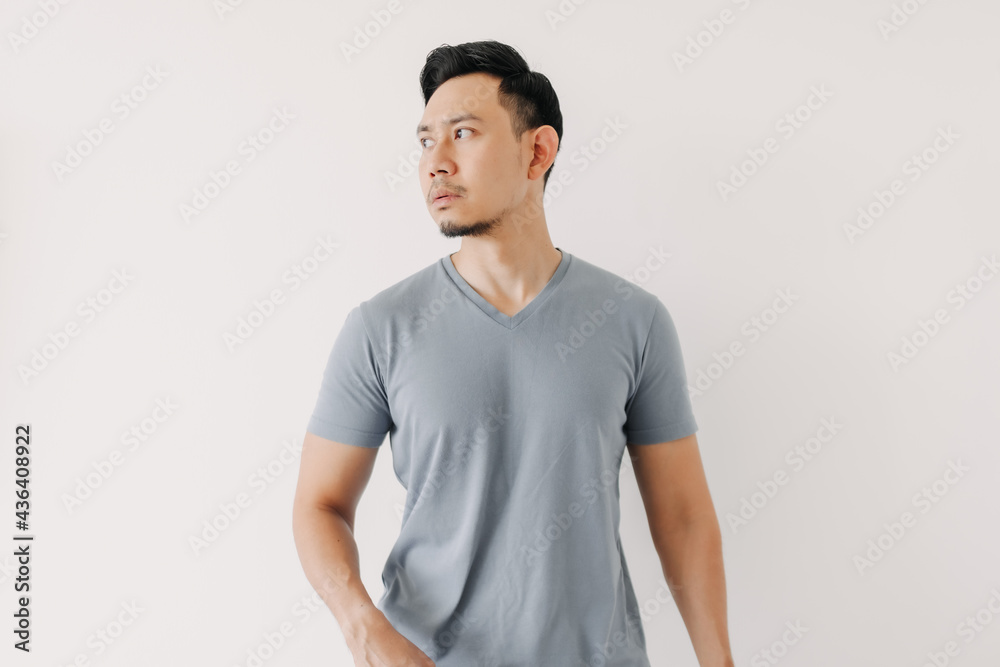 Normal portrait of an Asian man in a blue t-shirt isolated on white background. Normal portrait of an Asian man in a blue t-shirt isolated on white background.