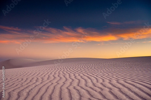 Orange and Blue Skies Over White Sand Dune Lines
