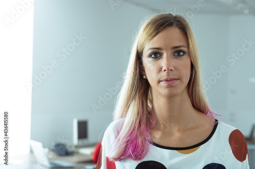 Attractive woman with trendy pink highlights in her long hair