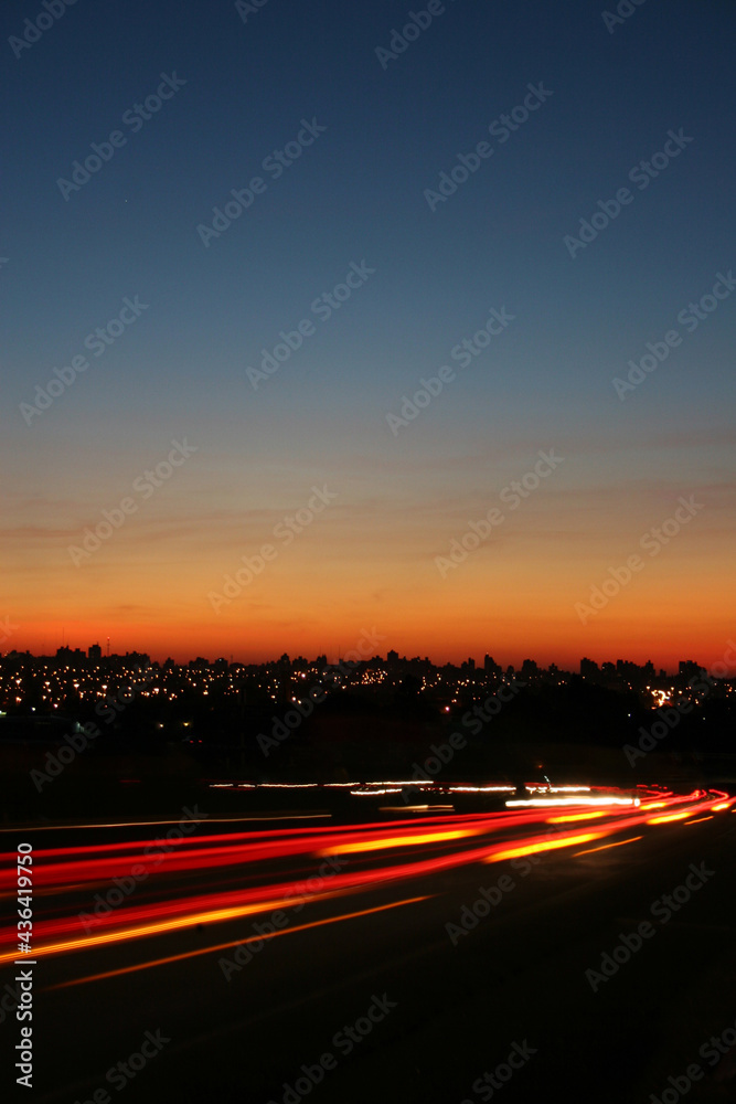 Creative shot of the movement of cars on the road with a beautiful sunset in the background