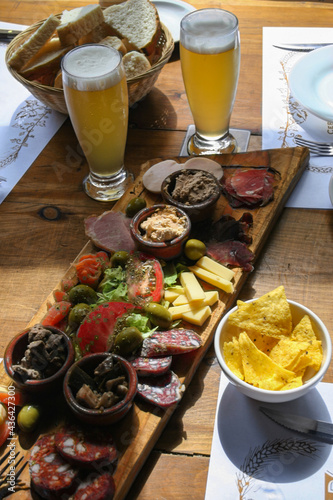Finger food table. With ingredients, bread and beer. Typical food in Argentina.