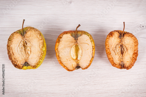 Old moldy apple, unhealthy and disgusting fruit photo