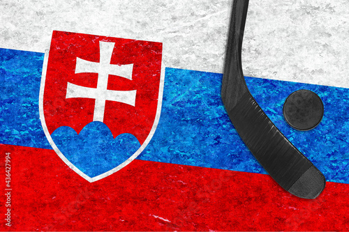 Image of the Slovak flag, hockey stick and puck