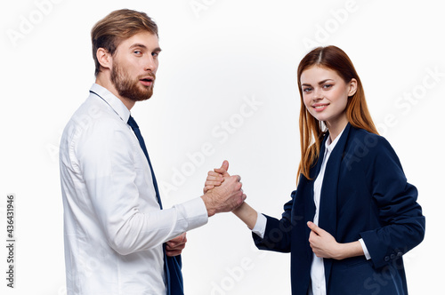 man and woman in suits are holding hands of work colleagues close-up