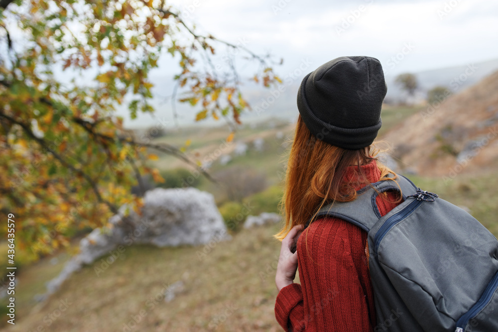 woman tourist with backpack on nature landscape travel adventure