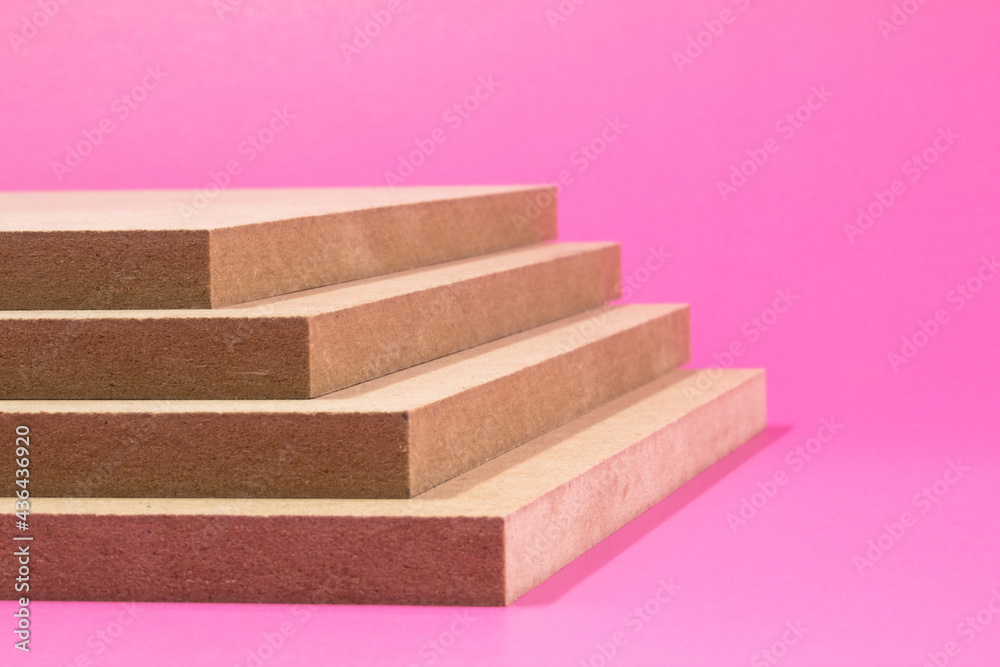 MDF is a medium-thick fiberboard made mainly of beech, spruce, fir and wood with the addition of polymer resins. The pink background especially highlights the plates. MDF is a medium-thick fiberboard made mainly of beech, spruce, fir and wood with the addition of polymer resins. The pink background especially highlights the plates.