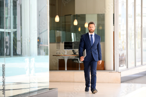 Manager in a luxury modern open space business center. Successful business man outside.