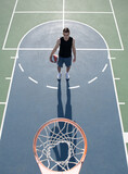 Angle view of man playing basketball, above hoop of man shooting basketball.