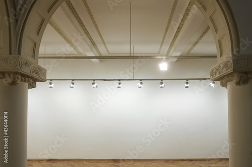 Interior of a empty white wall with spot lights at art gallery