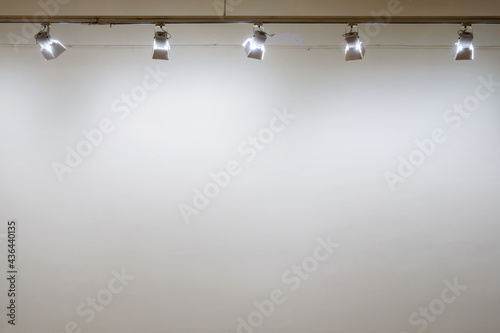 Interior with empty white wall with spot lights at art gallery
