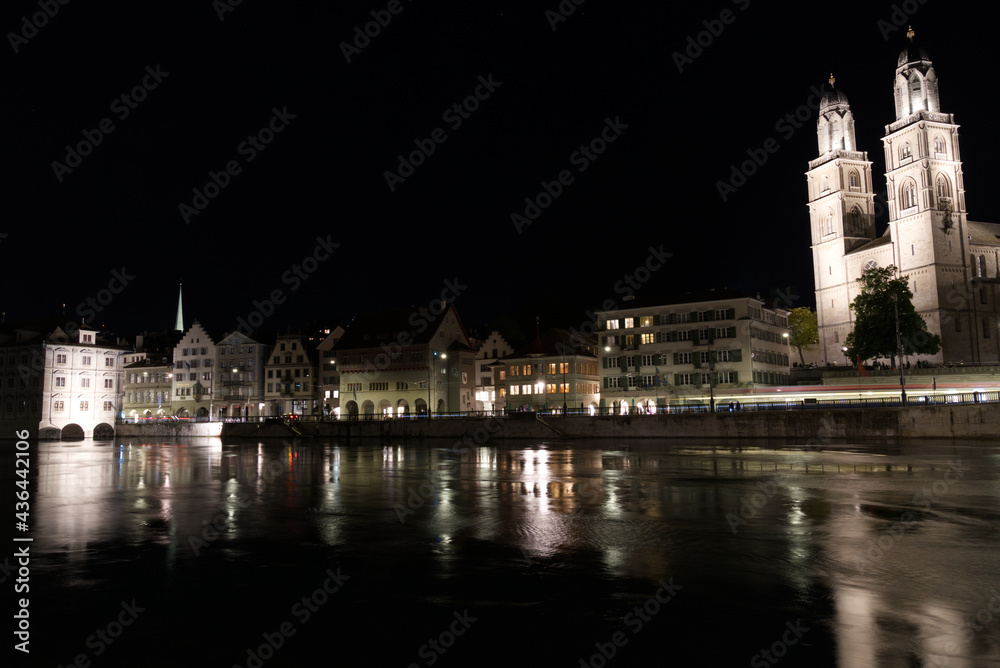 Old town of Zurich at night with church Grossmünster (great minster) with river Limmat. Photo taken May 29th, 2021, Zurich, Switzerland. Old town of Zurich at night with church Grossmünster (great minster) with river Limmat. Photo taken May 29th, 2021, Zurich, Switzerland.