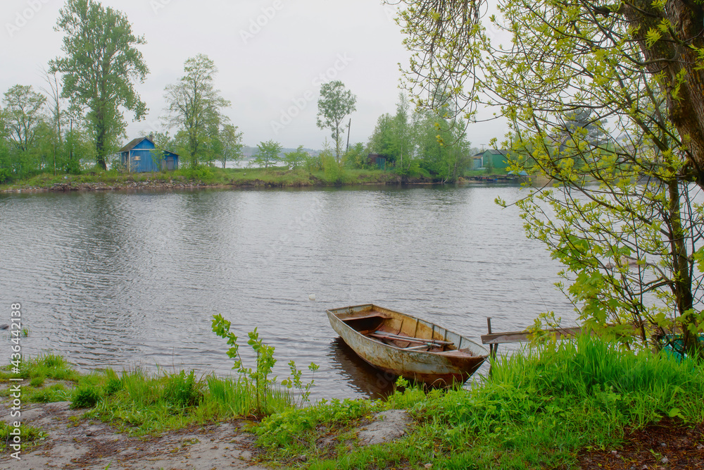 Fisherman boat is moored on the water near the shore. Fishing of Northern peoples. Fisherman boat is moored on the water near the shore. Fishing of Northern peoples.