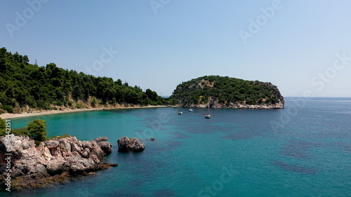 Drone aerial view of tourists enjoying a paradise luxury Yacht trip around Skopelos island, Greece, Aegean Sea, Europe. © Krasi Kanchev