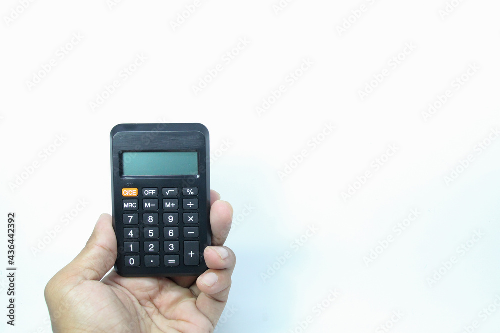 the concept of a hand is holding a calculator with a white background the concept of a hand is holding a calculator with a white background