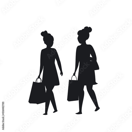 two girls walking with shopping bags silhouette