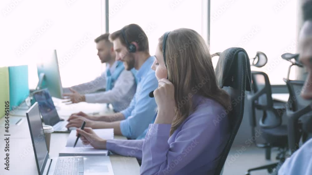 Contact center operator consulting clients in call center.