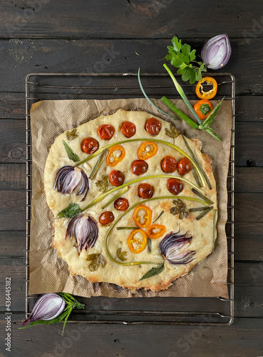 Floral painting focaccia, garden flatbread art, food trend. Old wooden background, top view