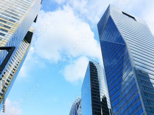 Huge skyscrapers with glass facades against the blue sky. Business center  offices of international corporations  business lifestyle.