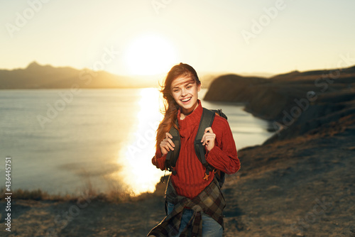 cheerful woman hiker with a backpack outdoors freedom travel vacation