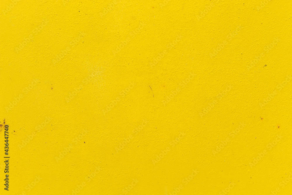 Old iron door painted in bright yellow close-up, for design Old iron door painted in bright yellow close-up, for design