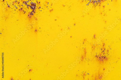 Old iron door with rust elements, painted in bright yellow close-up, for design