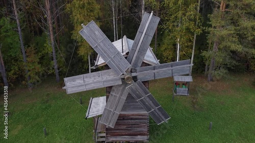 Flying with a drone over a traditional wooden windmill