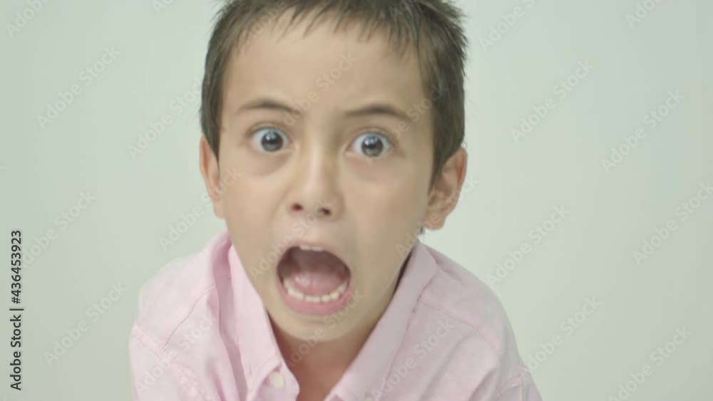 The cute boy spoke and made many expressions of emotions..Studio portrait, concept with white background. . The cute boy spoke and made many expressions of emotions..Studio portrait, concept with white background. .