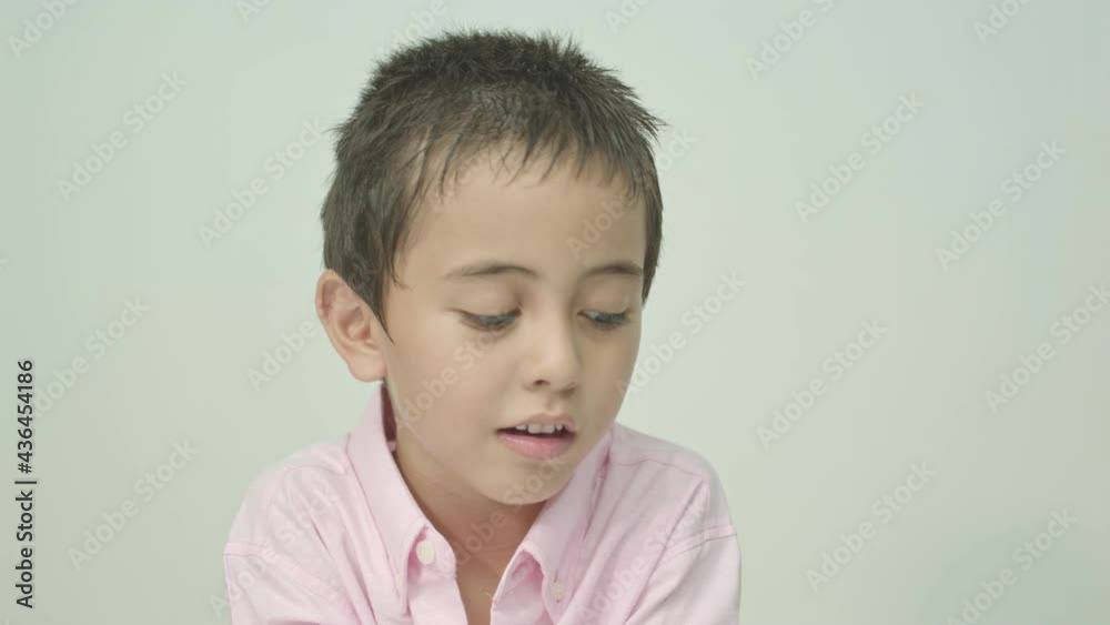 The cute boy spoke and made many expressions of emotions..Studio portrait, concept with white background. . The cute boy spoke and made many expressions of emotions..Studio portrait, concept with white background. .