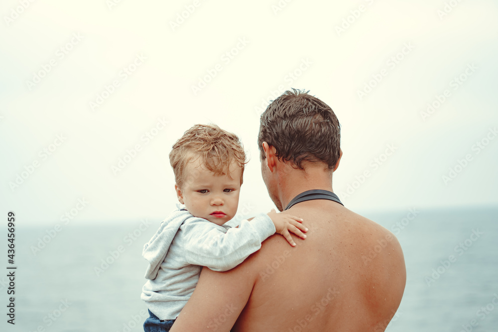 a father holds his son in his arms a father holds his son in his arms