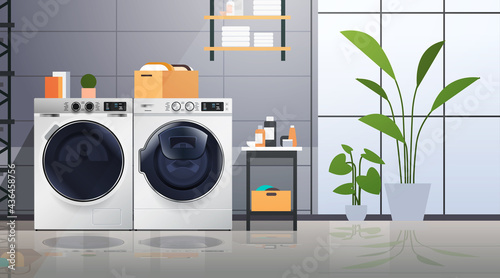 interior of laundry room with washing machines electric washers home appliance concept horizontal