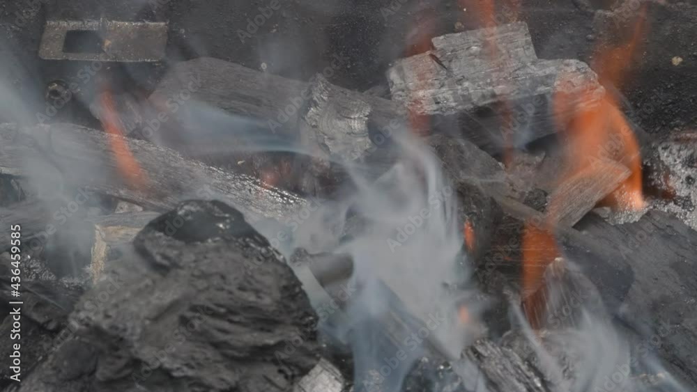 Embers glowing in blazing fire burning charcoal close up view Embers glowing in blazing fire burning charcoal close up view