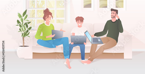 parents with child using laptops happy family spending time together modern living room interior