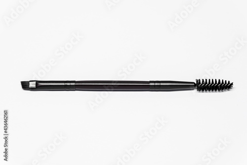 Professional dual purpose eyelash brush on white background