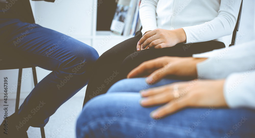 Group of people sitting in a circle during therapy. Meeting of business team participating in training Group of people sitting in a circle during therapy. Meeting of business team participating in training