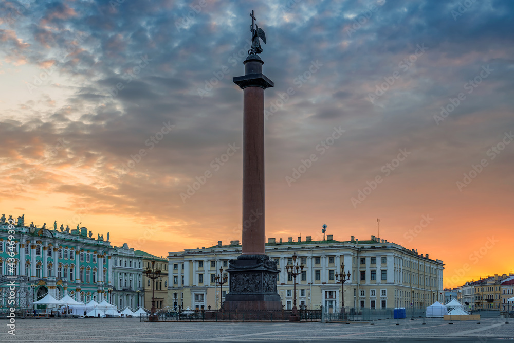 Sunrise view of Alexander Column  with dramatic sky in Palace Square, the Winter Palace, the Hermitage, in St Petersburg, Russia.