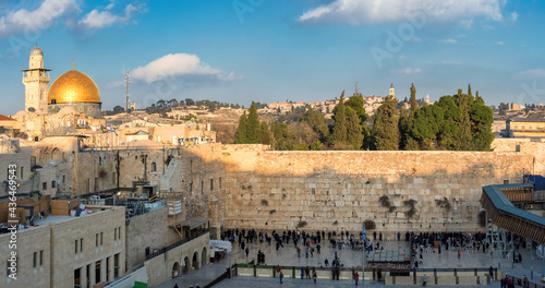Panoramic view in the old city of Jerusalem at sunset, including the Western Wall and golden Dome of the Rock.	