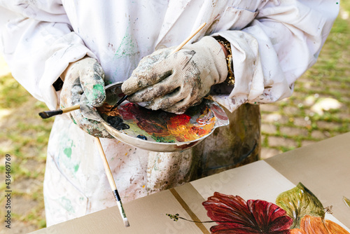 Bilde på lerret Unrecognizable person restoring and painting a wooden furniture
