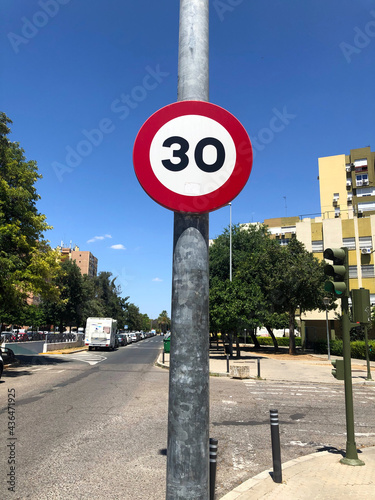 Traffic sign of maximum speed allowed for circulation on urban roads at 30 kilometers per hour, Seville, Andalusia, Spain photo