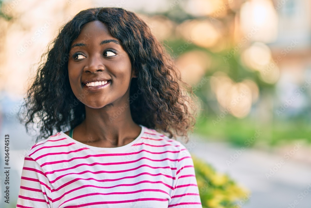 Young african american girl smiling happy standing at the city. Young african american girl smiling happy standing at the city.