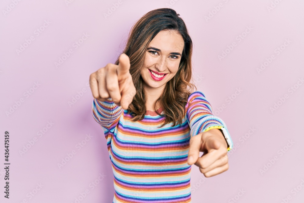 Young hispanic girl wearing casual clothes pointing to you and the camera with fingers, smiling positive and cheerful Young hispanic girl wearing casual clothes pointing to you and the camera with fingers, smiling positive and cheerful