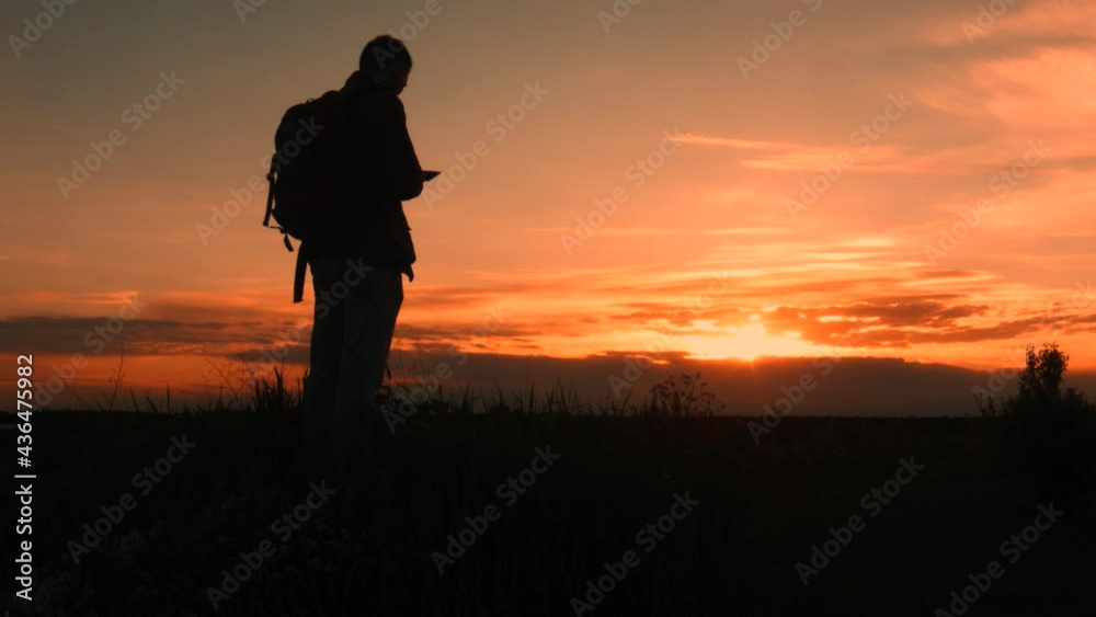Silhouette of a men hiker in the mountains with a sea of mist in the valley in the hours of sunset. Silhouette of a men hiker in the mountains with a sea of mist in the valley in the hours of sunset.