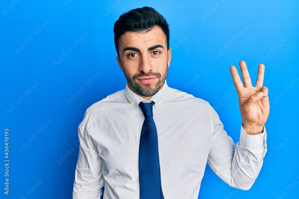 Young hispanic man wearing business clothes showing and pointing up with fingers number three while smiling confident and happy. Young hispanic man wearing business clothes showing and pointing up with fingers number three while smiling confident and happy.