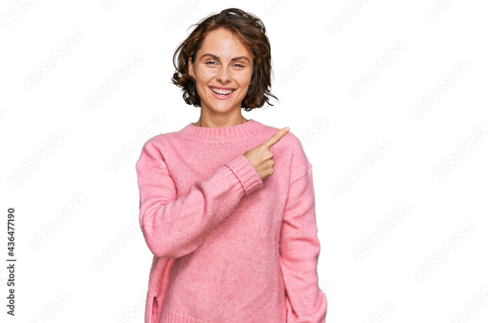 Fototapeta premium Young hispanic woman wearing casual clothes cheerful with a smile on face pointing with hand and finger up to the side with happy and natural expression