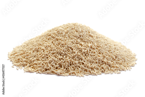 Pile of dry yeast isolated on white background, top view. Active dry yeast on a white background, top view. Dry yeast granules isolated on white background. Dry leavening is used in baked goods.