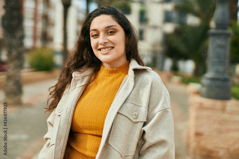 Young middle east woman smiling happy standing at the city. Young middle east woman smiling happy standing at the city.