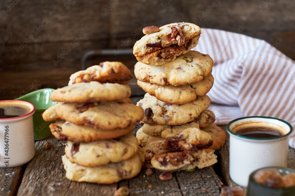 Cookies with caramel, pistachios and chocolate. Wooden background, side view Cookies with caramel, pistachios and chocolate. Wooden background, side view